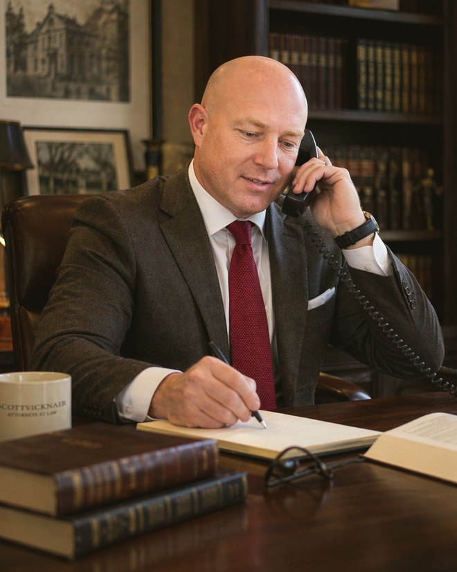 Brad P. Scott, Founding Partner of Scott Law Group, on the phone with a client
